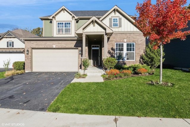 craftsman inspired home with aphalt driveway, board and batten siding, an attached garage, a front yard, and brick siding