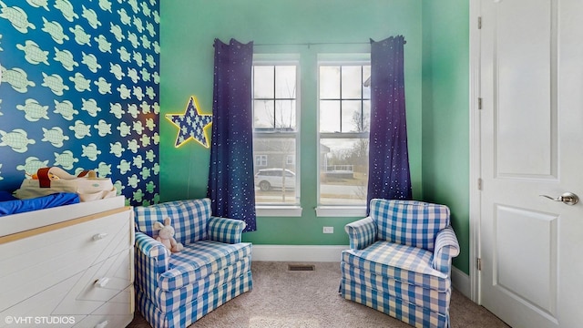 sitting room featuring visible vents, baseboards, and carpet flooring