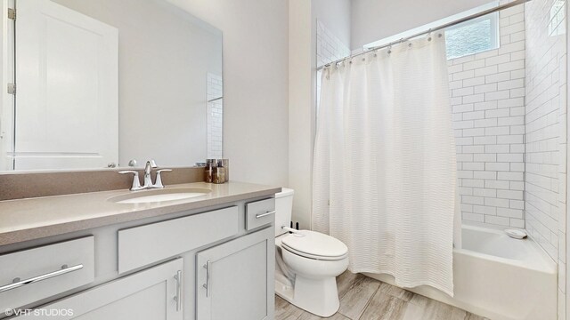 bathroom with toilet, vanity, shower / tub combo, and wood finished floors