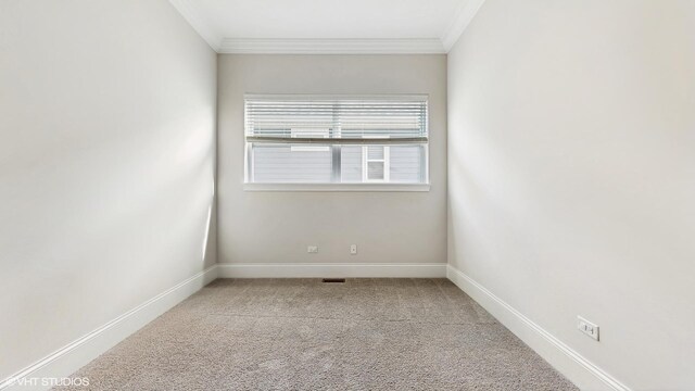 carpeted spare room with baseboards and ornamental molding