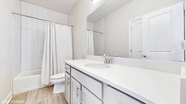 bathroom featuring shower / bath combination with curtain, toilet, and vanity