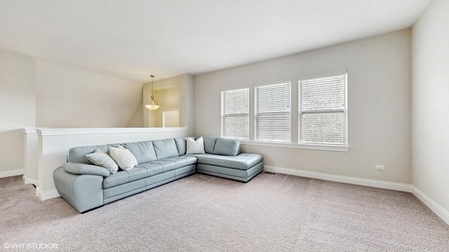 carpeted living area featuring baseboards