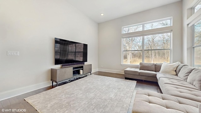 living area featuring recessed lighting, baseboards, and wood finished floors