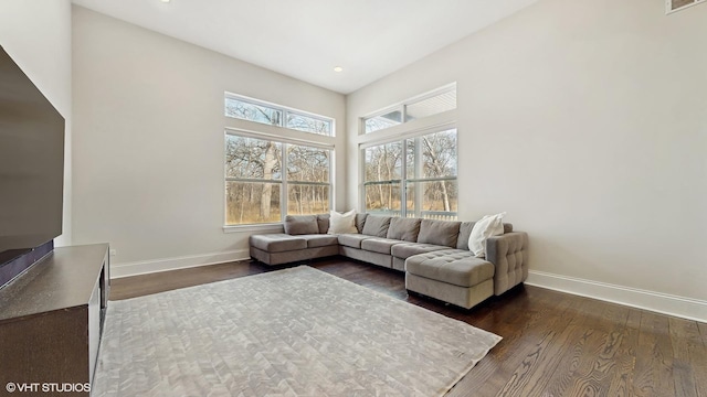 living area featuring recessed lighting, visible vents, baseboards, and dark wood-type flooring