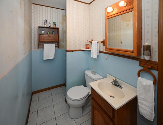 bathroom featuring wallpapered walls, baseboards, toilet, tile patterned floors, and vanity