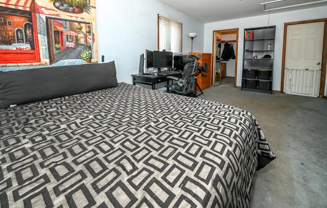 carpeted bedroom featuring a spacious closet and attic access