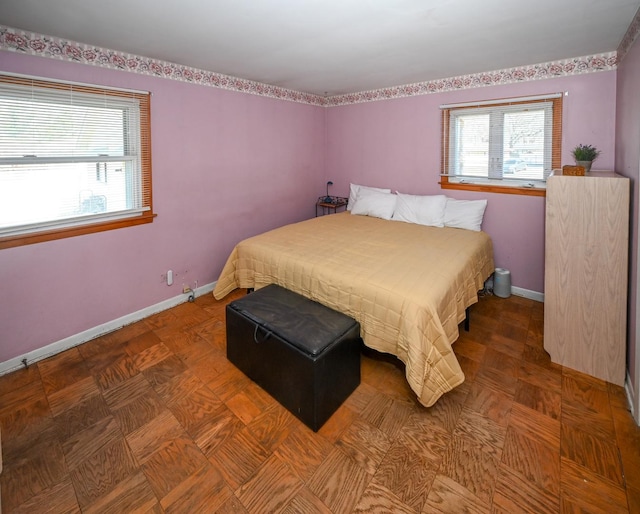 bedroom with multiple windows and baseboards