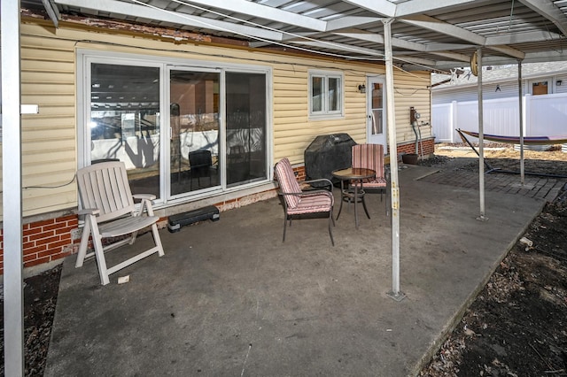 view of patio featuring a trampoline, area for grilling, and fence