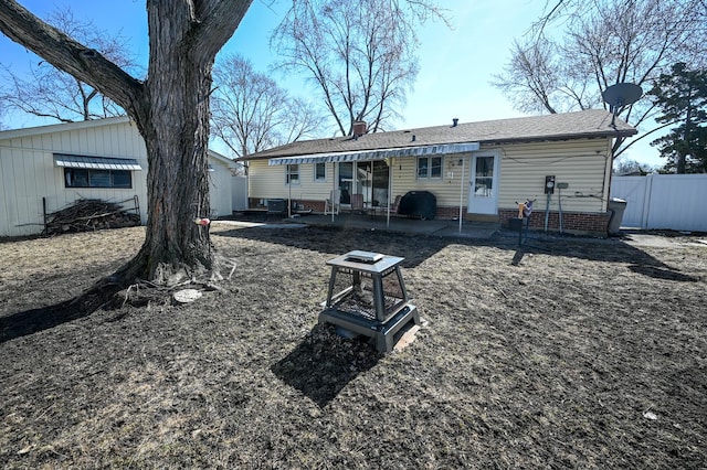 back of house featuring cooling unit, a patio, a shingled roof, and fence