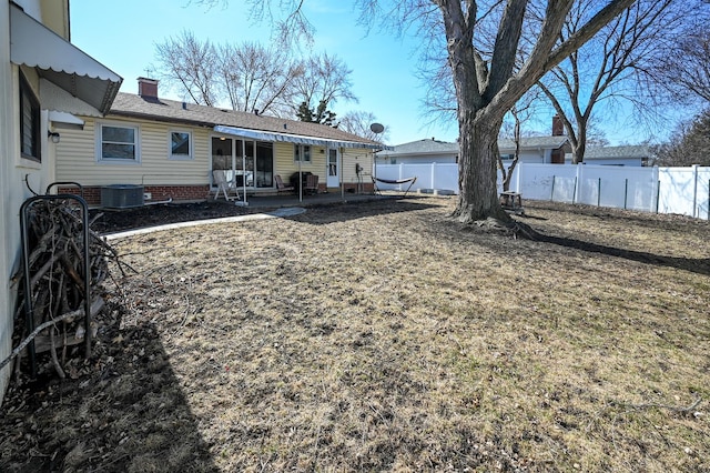 view of yard with a patio, central AC, and a fenced backyard