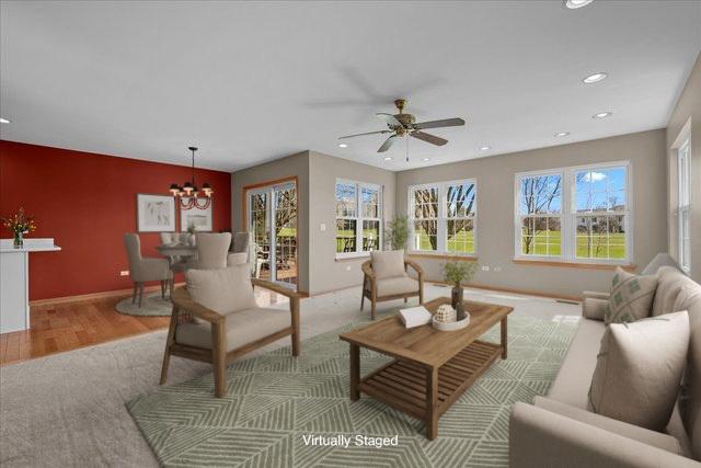 13731 S Tamarack Dr, Plainfield, IL 60544 - living area featuring wood finished floors, baseboards, ceiling fan with notable chandelier, and recessed lighting