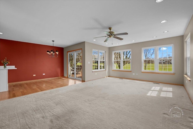13731 S Tamarack Dr, Plainfield, IL 60544 - interior space featuring ceiling fan with notable chandelier, wood finished floors, recessed lighting, carpet flooring, and baseboards