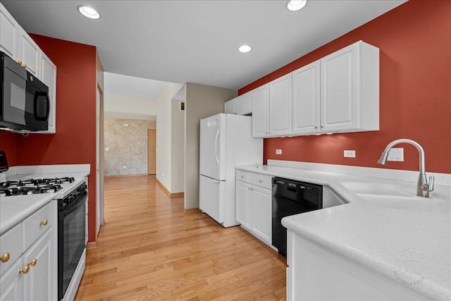 13731 S Tamarack Dr, Plainfield, IL 60544 - kitchen featuring a sink, black appliances, white cabinetry, light countertops, and light wood-style floors