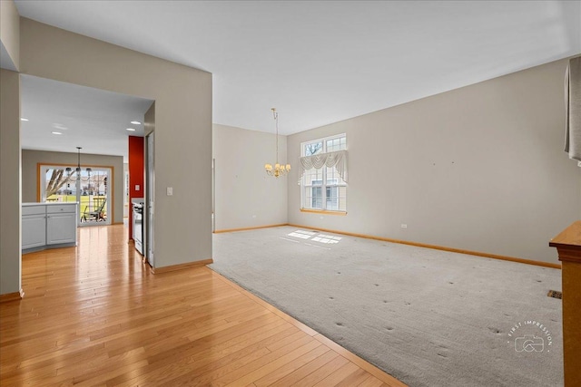 13731 S Tamarack Dr, Plainfield, IL 60544 - interior space with light wood-type flooring, a chandelier, and baseboards