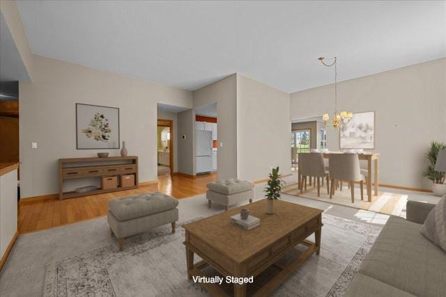 13731 S Tamarack Dr, Plainfield, IL 60544 - living area featuring an inviting chandelier, baseboards, and wood finished floors