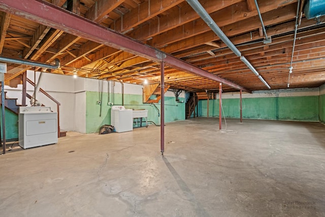 unfinished basement with washer / clothes dryer and stairs