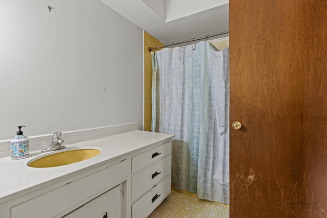 bathroom featuring curtained shower, vanity, and tile patterned floors