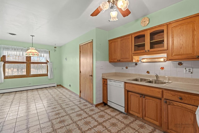 kitchen with light countertops, visible vents, baseboard heating, white dishwasher, and a sink