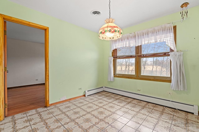 empty room featuring a baseboard heating unit, visible vents, baseboards, and tile patterned floors