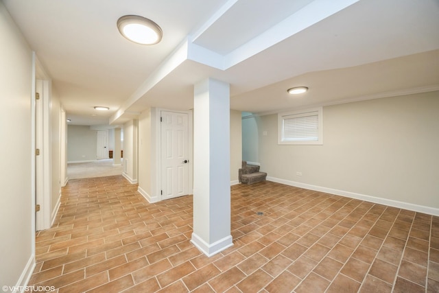 finished basement with stairway and baseboards