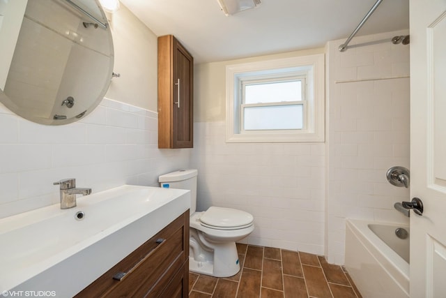 bathroom with shower / bath combination, tile walls, toilet, and vanity