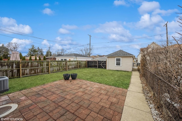 view of patio featuring an outbuilding, central AC, and a fenced backyard