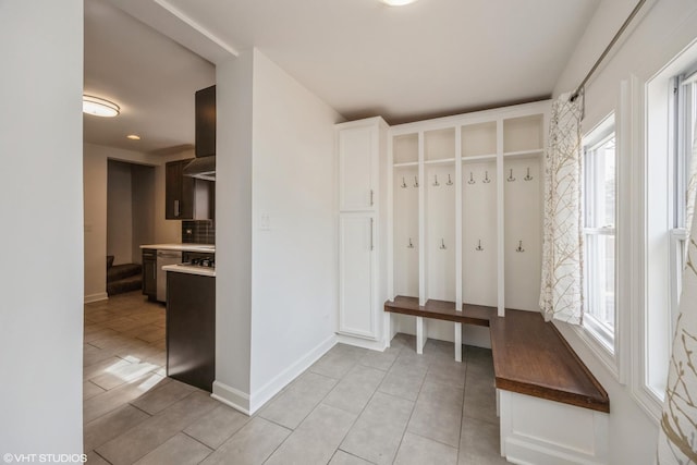 mudroom featuring baseboards and light tile patterned floors