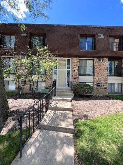 view of property with entry steps and brick siding