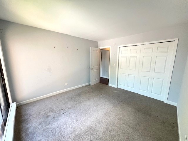 unfurnished bedroom with carpet, baseboards, and a closet