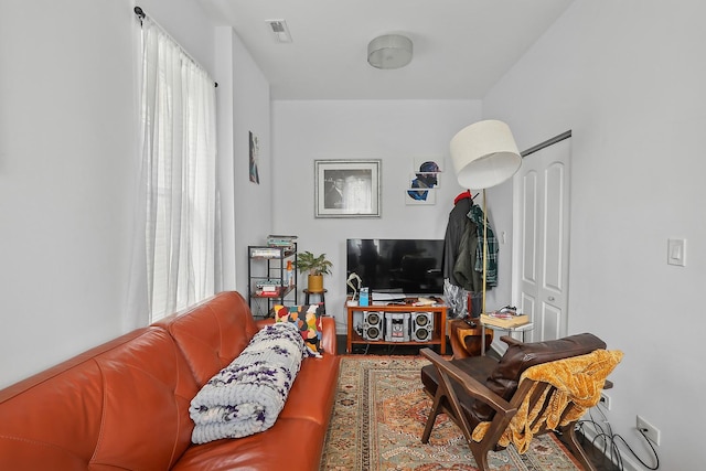 living room with visible vents and wood finished floors