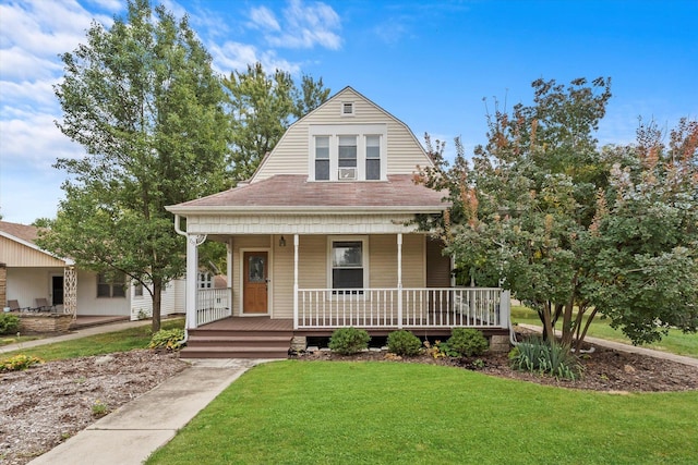 view of front of property with covered porch, a front lawn, a shingled roof, and a gambrel roof