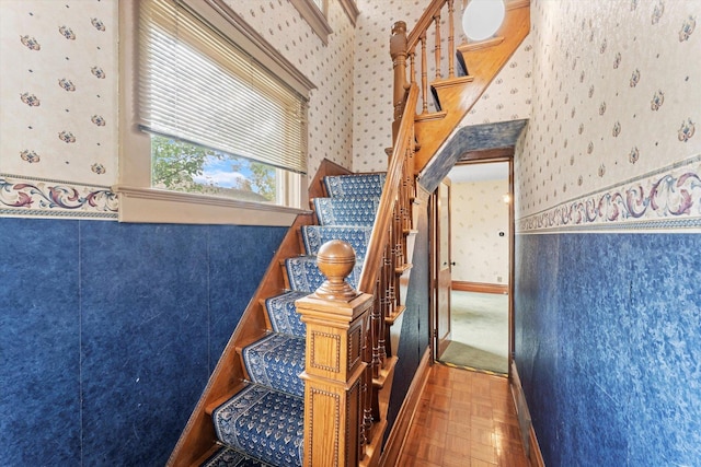 stairs with wallpapered walls