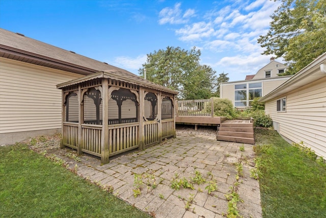 view of patio / terrace featuring a wooden deck and a gazebo