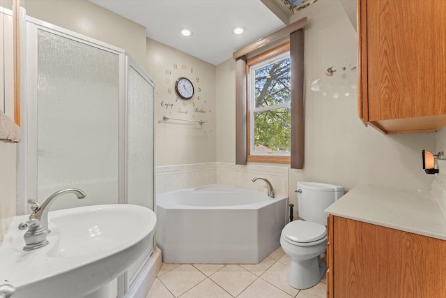 bathroom with toilet, a stall shower, a sink, tile patterned flooring, and a bath