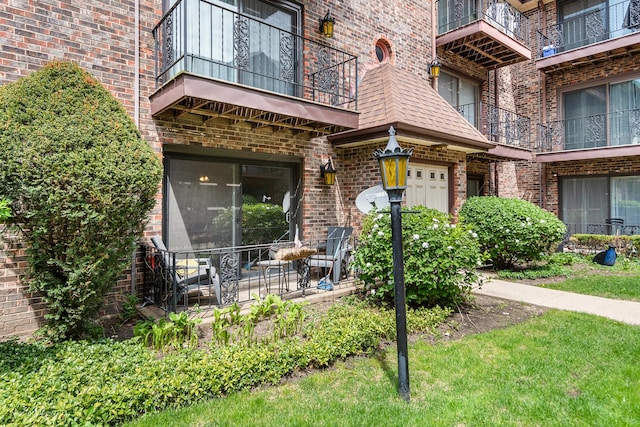 6453C N NW Hwy Unit 1S, Chicago, IL 60631 - view of exterior entry featuring brick siding, a balcony, and a garage