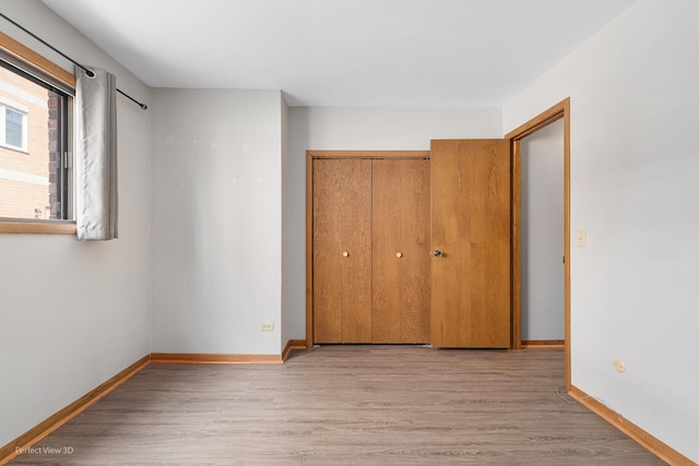 6453C N NW Hwy Unit 1S, Chicago, IL 60631 - unfurnished bedroom with wood finished floors, a closet, and baseboards