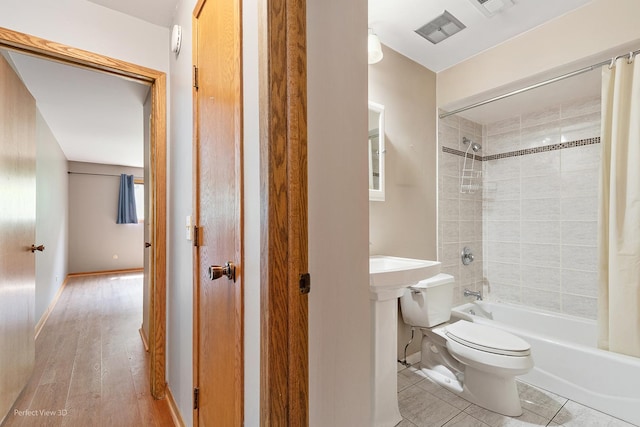 6453C N NW Hwy Unit 1S, Chicago, IL 60631 - bathroom featuring toilet, shower / tub combo with curtain, tile patterned flooring, and baseboards