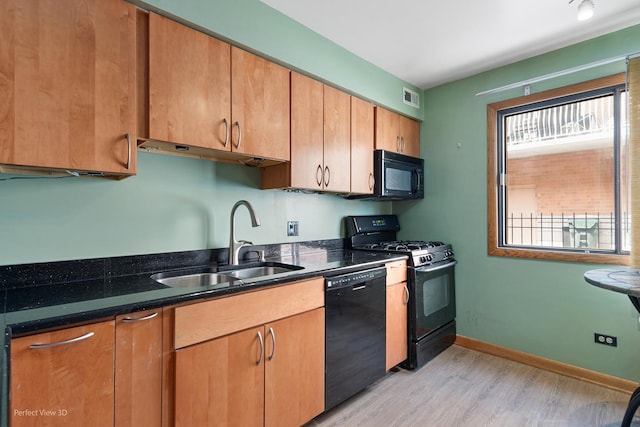 6453C N NW Hwy Unit 1S, Chicago, IL 60631 - kitchen with black appliances, a sink, light wood-type flooring, and dark stone countertops