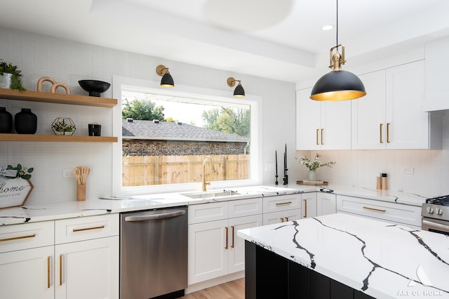 kitchen featuring appliances with stainless steel finishes, white cabinets, decorative backsplash, and light stone counters