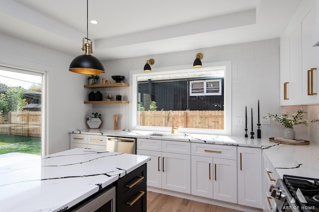 kitchen featuring appliances with stainless steel finishes, white cabinets, and light stone countertops