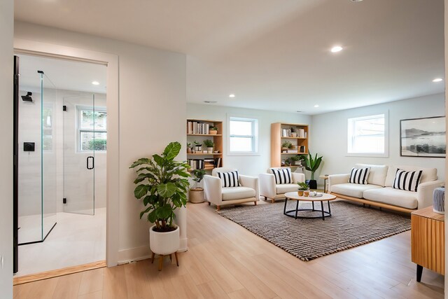 living area with light wood-style floors and recessed lighting