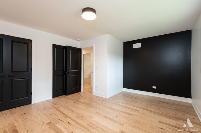 unfurnished bedroom featuring light wood-style flooring and baseboards