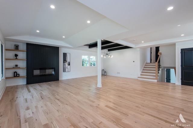 unfurnished living room featuring light wood-type flooring, stairs, a fireplace, and recessed lighting