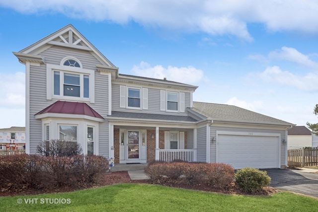 view of front of home with a shingled roof, fence, aphalt driveway, covered porch, and an attached garage