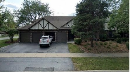 view of front of home with concrete driveway and an attached garage