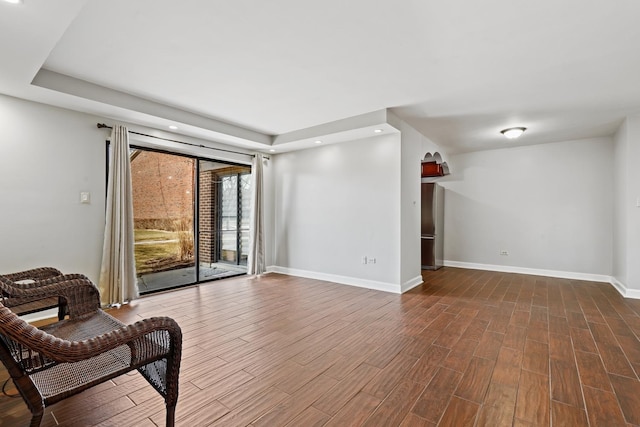 sitting room featuring recessed lighting, baseboards, and dark wood-type flooring