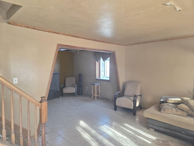 living area with tile patterned flooring and stairs