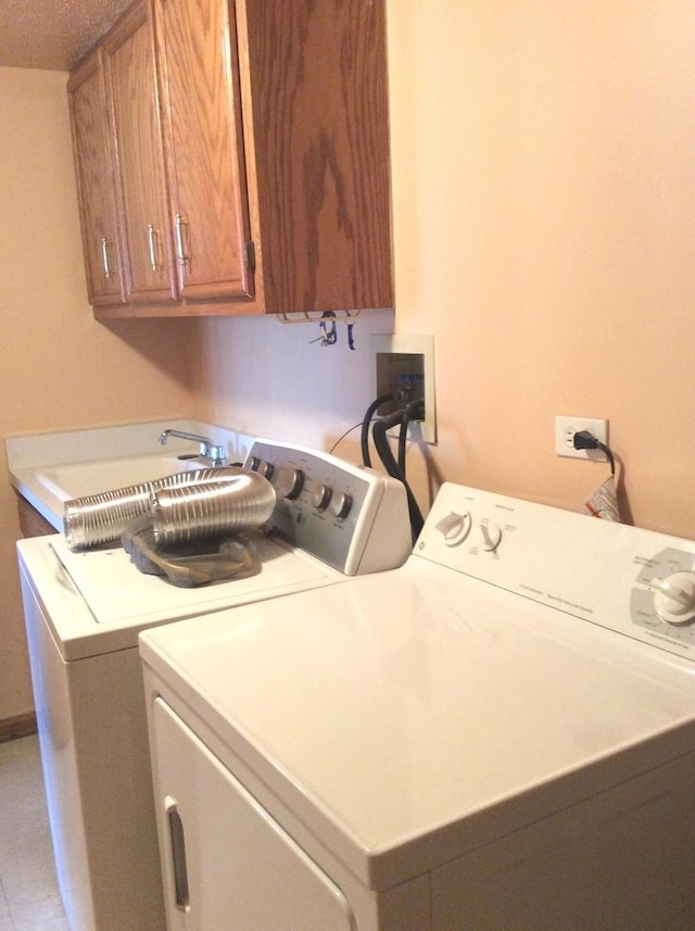 laundry room with cabinet space and separate washer and dryer