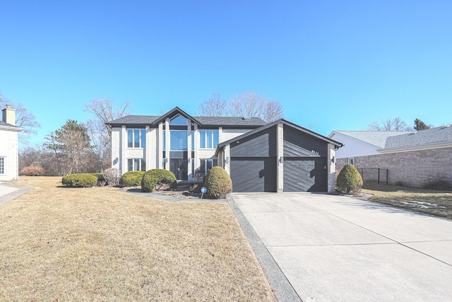 view of front of property featuring concrete driveway and a front yard