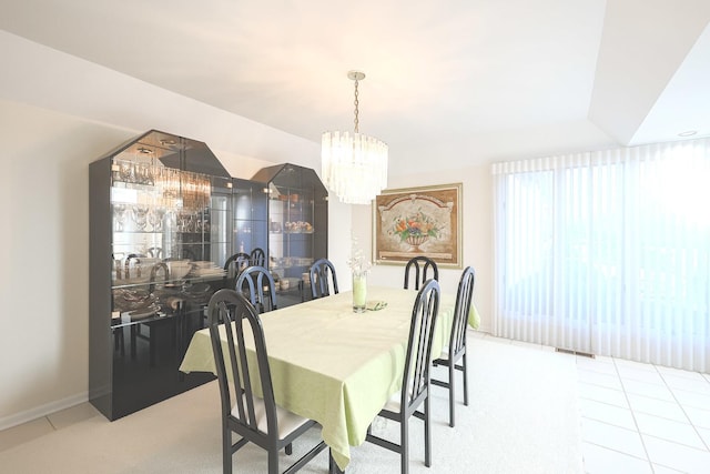 tiled dining space with a notable chandelier and visible vents